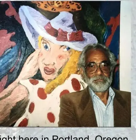 Robert Colescott standing in front of one of his paintings