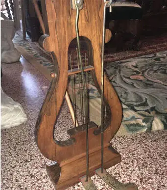 The piano's carved lyre pedal mechanism
