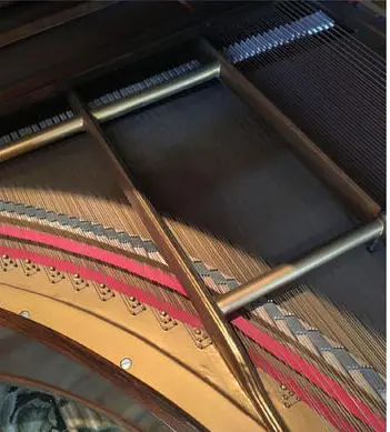 Close-up of the piano's iron frame and strings
