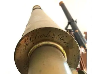 Close-up of the A. Clark & Sons signature engraved on the telescope's brass barrel