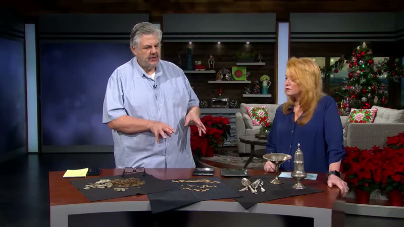 Gary Germer reviewing silver and gold items on set